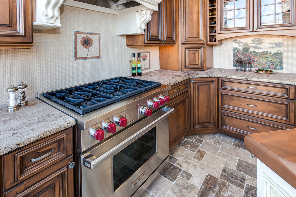 Inspiration for a small timeless travertine floor kitchen remodel in Denver with raised-panel cabinets, medium tone wood cabinets, granite countertops, beige backsplash, ceramic backsplash, stainless steel appliances and an island