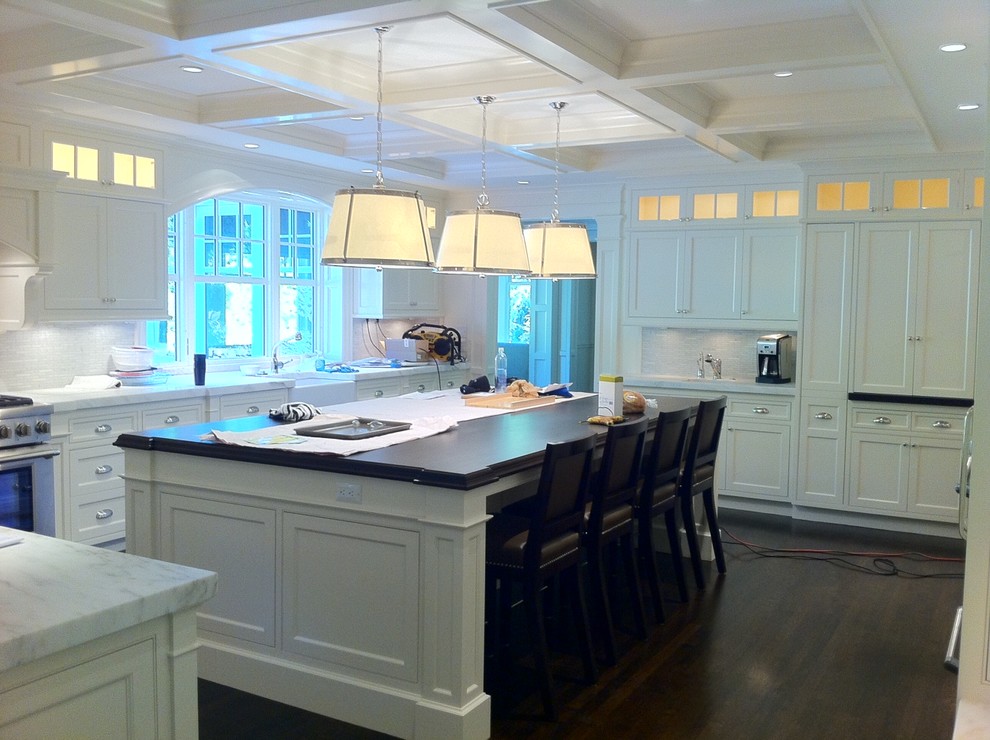 Eat-in kitchen - traditional dark wood floor eat-in kitchen idea in Boston with a farmhouse sink, recessed-panel cabinets, white cabinets, marble countertops and an island