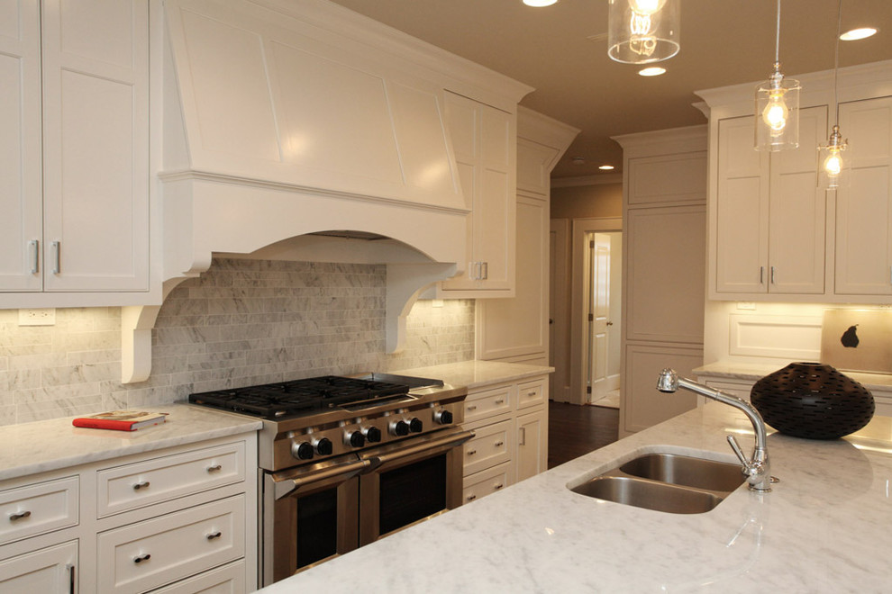 Example of a mountain style kitchen design in Atlanta with shaker cabinets, stainless steel appliances and marble countertops