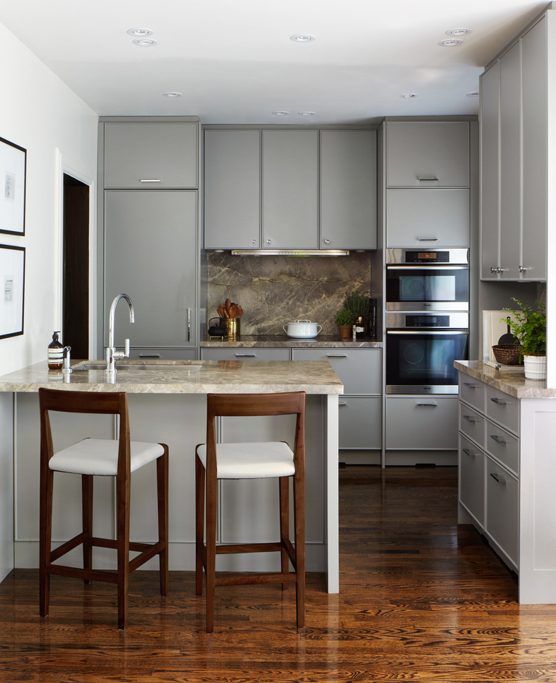 Small transitional galley medium tone wood floor eat-in kitchen photo in Toronto with an undermount sink, gray cabinets, marble countertops, gray backsplash, stone slab backsplash, stainless steel appliances, beaded inset cabinets and a peninsula