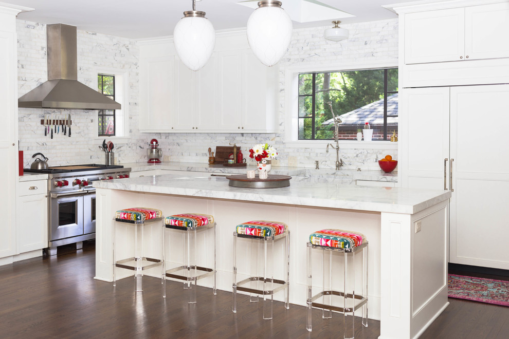 This is an example of a bohemian l-shaped kitchen in Atlanta with shaker cabinets, white cabinets, white splashback, marble splashback, integrated appliances, dark hardwood flooring, an island, brown floors and white worktops.
