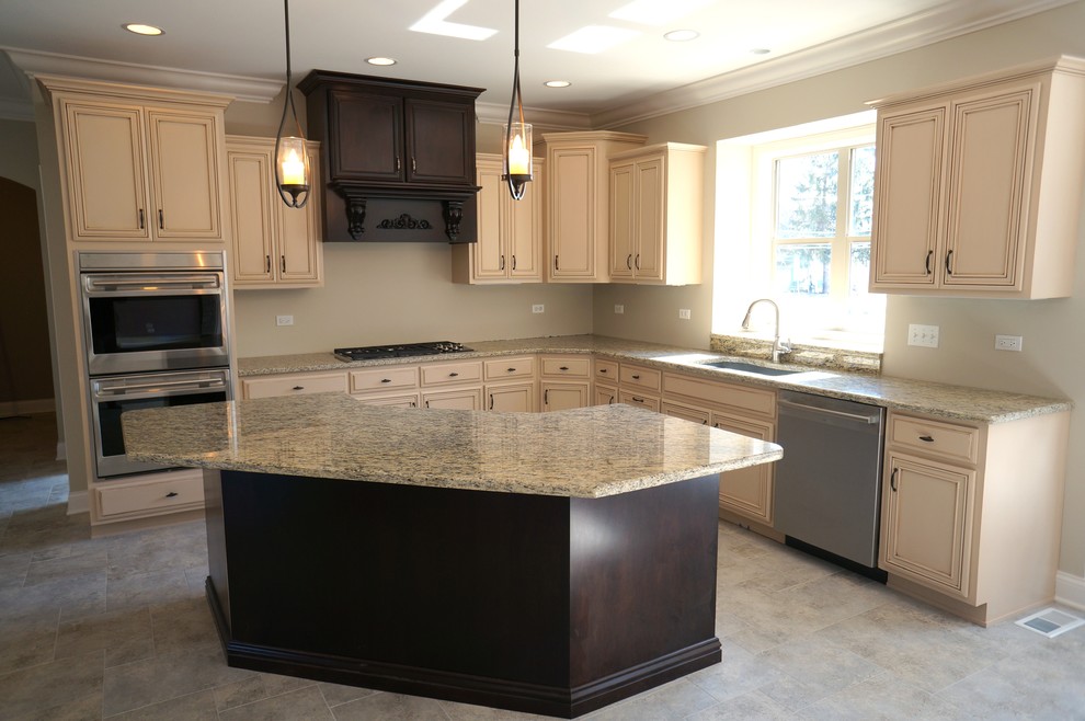 Design ideas for a large classic kitchen/diner in Chicago with a submerged sink, dark wood cabinets, granite worktops, stainless steel appliances and travertine flooring.
