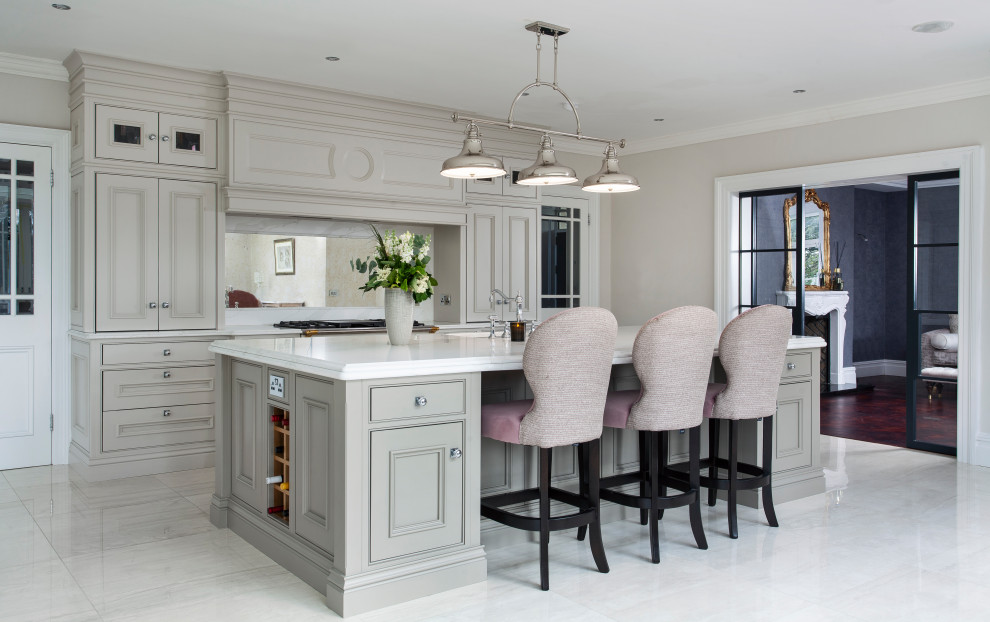 Example of a huge transitional l-shaped gray floor enclosed kitchen design in Other with an undermount sink, recessed-panel cabinets, gray cabinets, mirror backsplash, paneled appliances, an island and white countertops