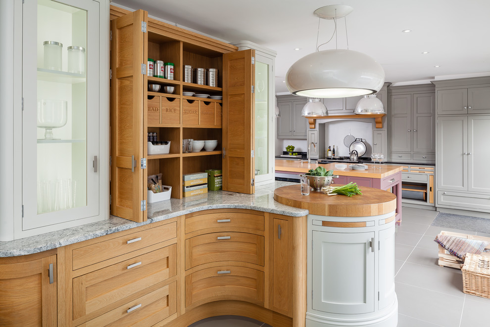 Inspiration for a medium sized contemporary single-wall kitchen/diner in Other with medium wood cabinets, granite worktops, black appliances, an island and grey floors.
