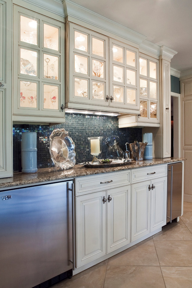Design ideas for a large classic kitchen/diner in Charleston with raised-panel cabinets, beige cabinets, granite worktops, blue splashback, stone tiled splashback, stainless steel appliances and travertine flooring.