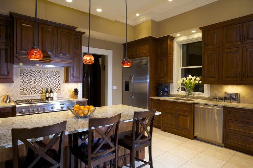Example of a trendy kitchen design in St Louis with mosaic tile backsplash, stainless steel appliances, an undermount sink, raised-panel cabinets, dark wood cabinets, granite countertops and multicolored backsplash