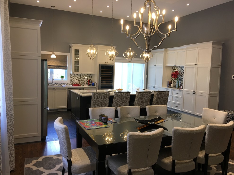 Large classic u-shaped open plan kitchen in Montreal with a submerged sink, shaker cabinets, white cabinets, granite worktops, multi-coloured splashback, mosaic tiled splashback, stainless steel appliances, ceramic flooring, an island and black floors.
