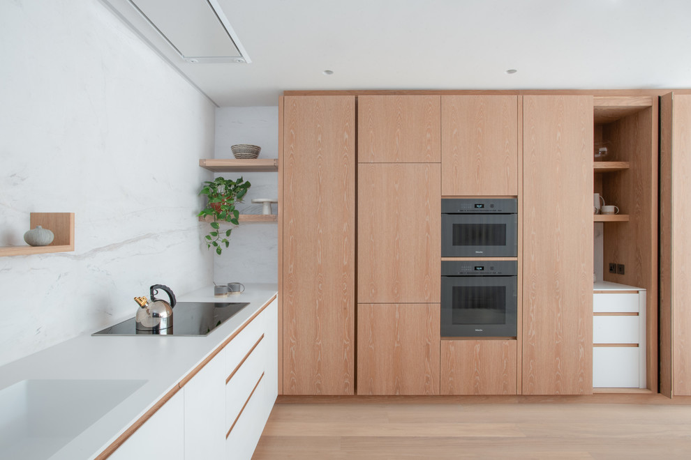 Medium sized modern l-shaped kitchen/diner in London.