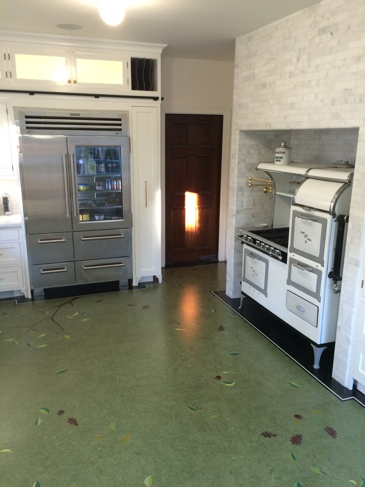 Photo of a kitchen in Los Angeles with a belfast sink and green floors.