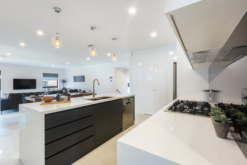Design ideas for a medium sized contemporary single-wall kitchen pantry in Canberra - Queanbeyan with a built-in sink, white cabinets, composite countertops, metallic splashback, mirror splashback, stainless steel appliances, ceramic flooring, an island and beige floors.