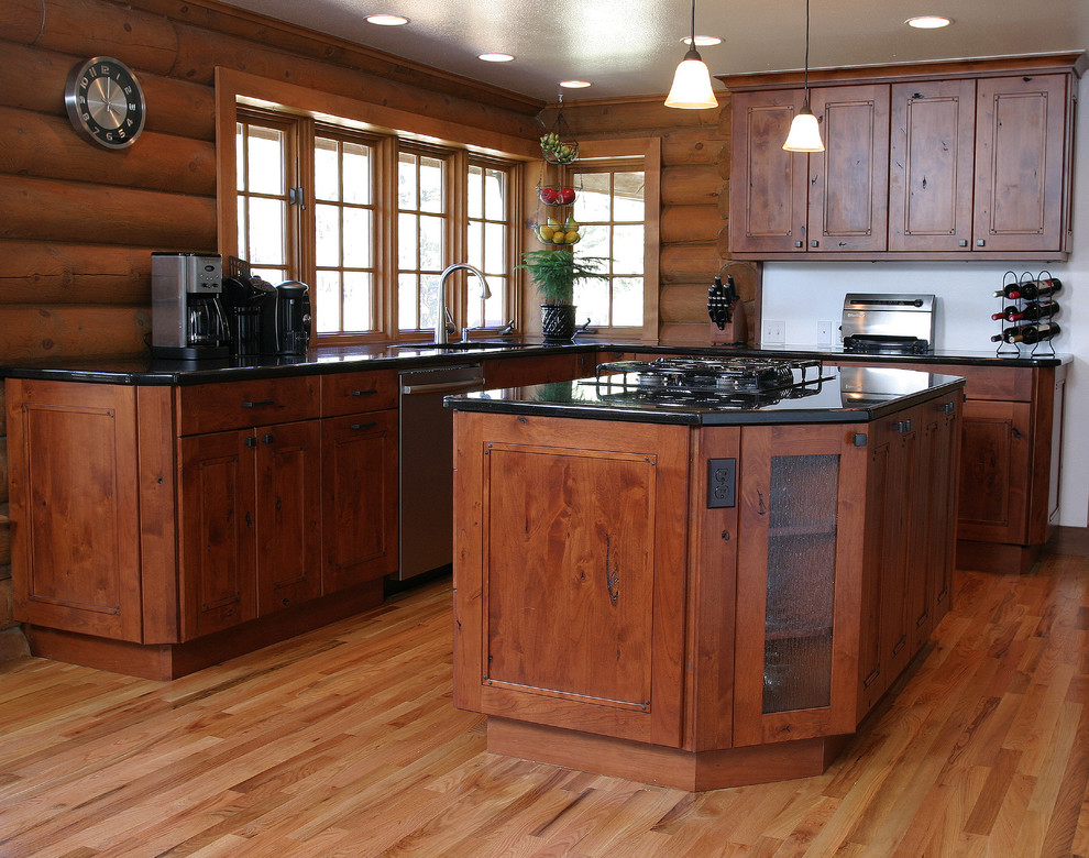 This is an example of a large rustic u-shaped kitchen/diner in Denver with a submerged sink, flat-panel cabinets, dark wood cabinets, granite worktops, beige splashback, stainless steel appliances, dark hardwood flooring and an island.