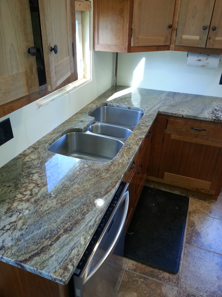 Eat-in kitchen - mid-sized country l-shaped porcelain tile and multicolored floor eat-in kitchen idea in Other with an undermount sink, recessed-panel cabinets, light wood cabinets, granite countertops, stainless steel appliances, no island and multicolored countertops