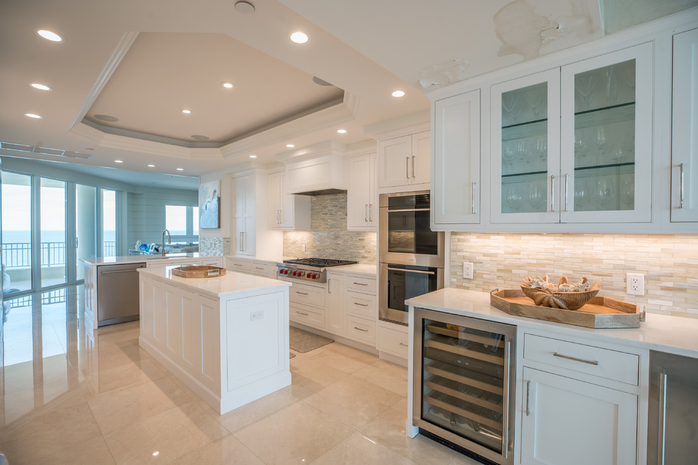 Example of a beach style kitchen design in Other with beaded inset cabinets and white cabinets