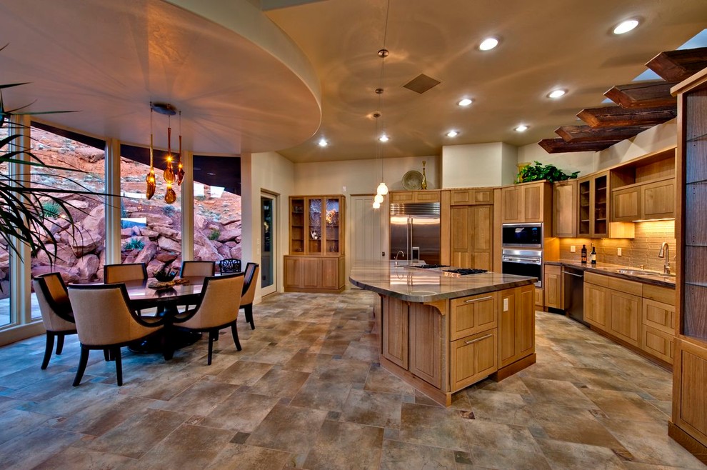 Trendy eat-in kitchen photo in Salt Lake City with an undermount sink, recessed-panel cabinets, medium tone wood cabinets, beige backsplash, stainless steel appliances and an island