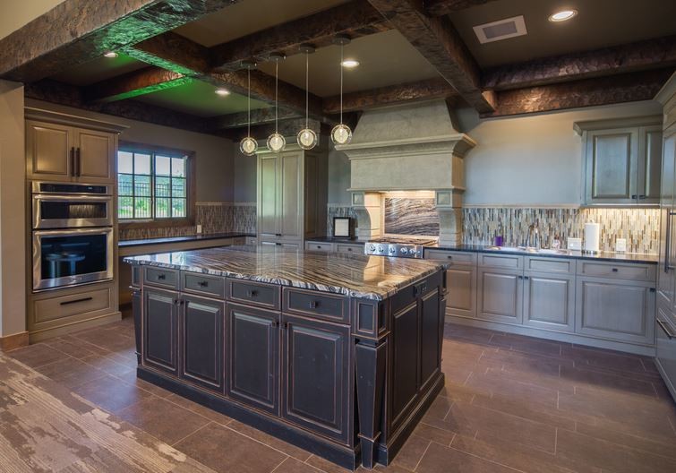 Rustic u-shaped open plan kitchen in New York with a built-in sink, raised-panel cabinets, distressed cabinets, granite worktops, metal splashback, stainless steel appliances, porcelain flooring and an island.