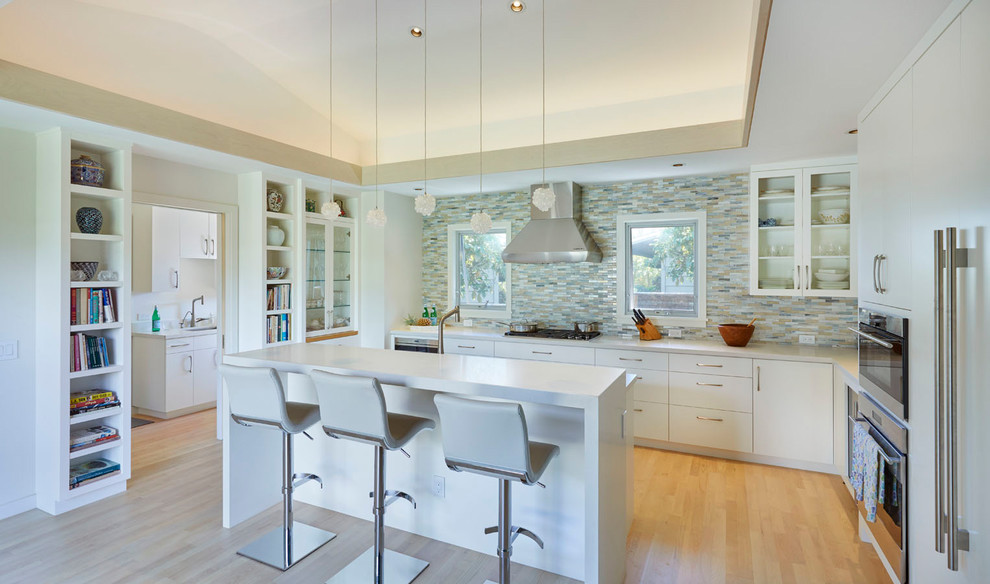 Inspiration for a mid-sized zen u-shaped bamboo floor and brown floor kitchen pantry remodel in Hawaii with flat-panel cabinets, white cabinets, multicolored backsplash and an island