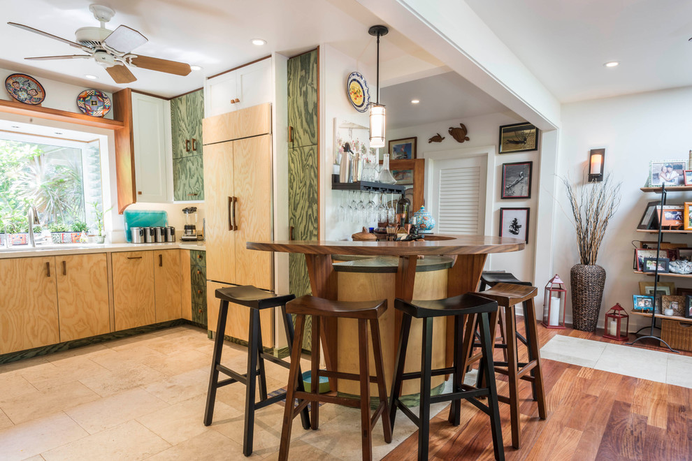 Inspiration for a mid-sized coastal u-shaped travertine floor and beige floor enclosed kitchen remodel in Hawaii with an undermount sink, beaded inset cabinets, light wood cabinets, wood countertops, paneled appliances and a peninsula