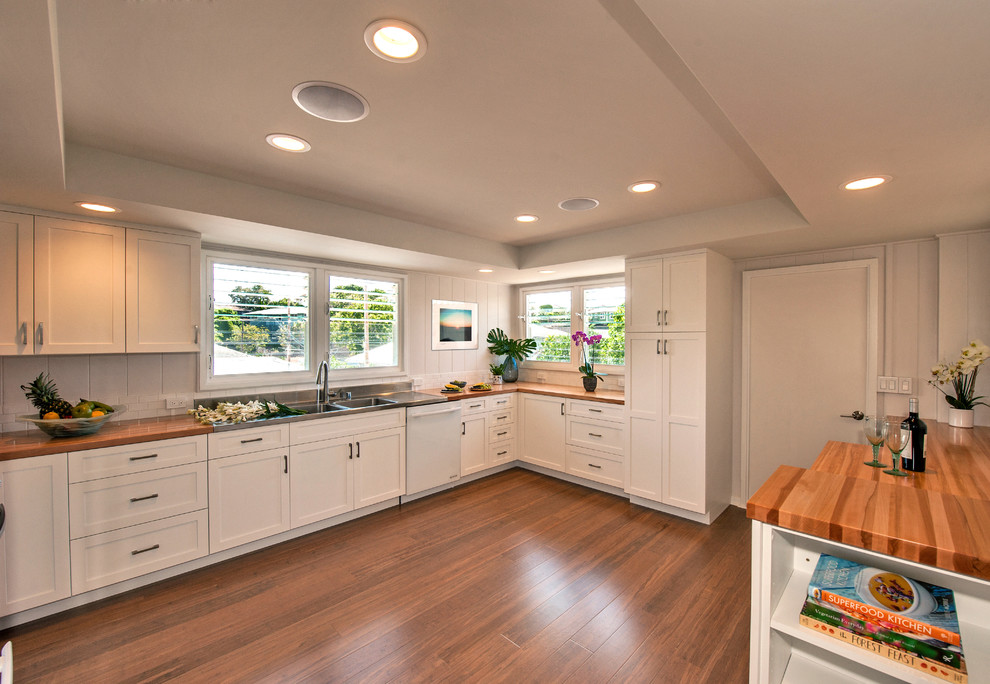 Photo of a traditional kitchen in Hawaii with shaker cabinets, white cabinets, wood worktops, white appliances, bamboo flooring and no island.