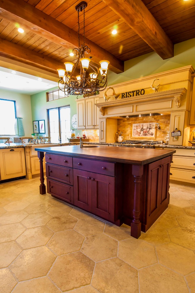 Large mountain style l-shaped limestone floor eat-in kitchen photo in Phoenix with raised-panel cabinets, beige cabinets, granite countertops, beige backsplash, mosaic tile backsplash, stainless steel appliances and an island