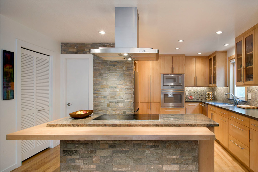 Example of a mid-sized trendy l-shaped light wood floor eat-in kitchen design in Denver with an undermount sink, flat-panel cabinets, light wood cabinets, granite countertops, multicolored backsplash, stone tile backsplash, stainless steel appliances and an island