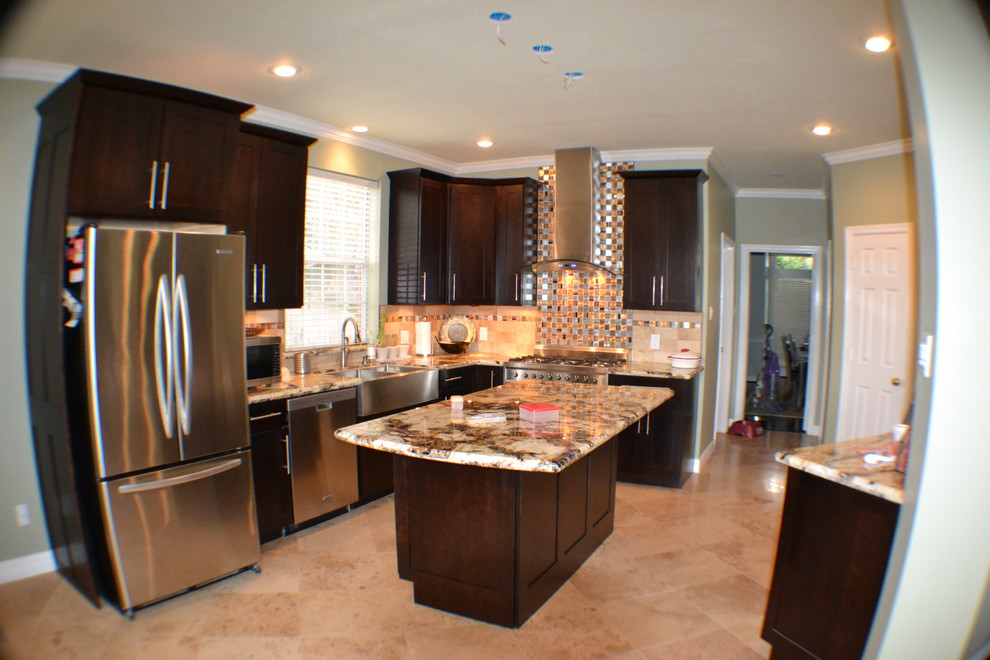 Example of a mid-sized classic ceramic tile and brown floor kitchen design in Houston with a farmhouse sink, shaker cabinets, dark wood cabinets, multicolored backsplash, stone tile backsplash, stainless steel appliances and an island