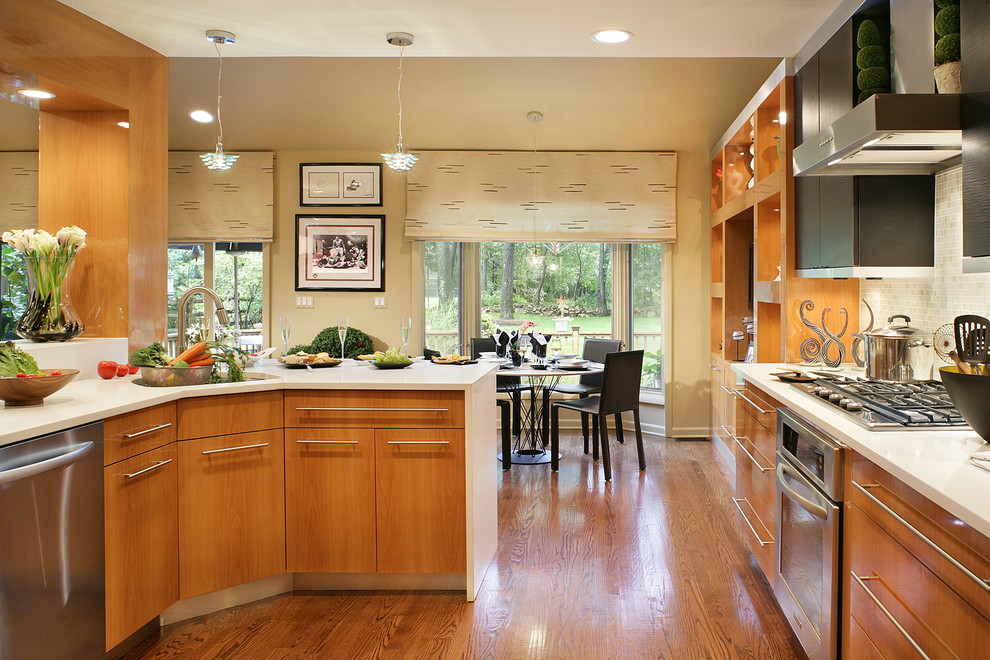 Foto de cocina comedor contemporánea con armarios con paneles lisos, puertas de armario de madera oscura y electrodomésticos de acero inoxidable