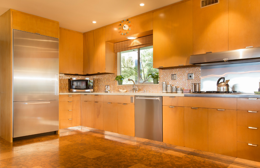Large trendy galley laminate floor and brown floor eat-in kitchen photo in Santa Barbara with a drop-in sink, flat-panel cabinets, medium tone wood cabinets, solid surface countertops, beige backsplash, stone tile backsplash, stainless steel appliances and no island
