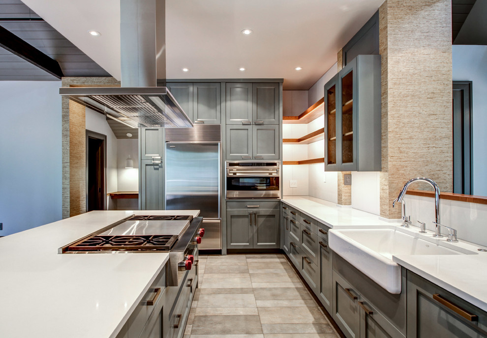 Inspiration for a large contemporary u-shaped porcelain tile eat-in kitchen remodel in Other with a farmhouse sink, shaker cabinets, blue cabinets, solid surface countertops, white backsplash, glass sheet backsplash, stainless steel appliances and an island