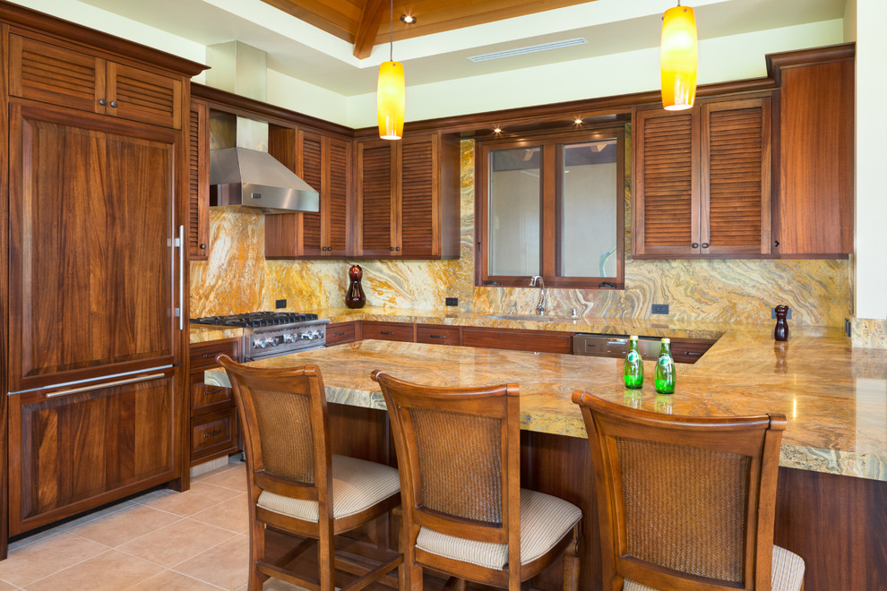 Inspiration for a mid-sized tropical u-shaped ceramic tile eat-in kitchen remodel in Hawaii with a double-bowl sink, louvered cabinets, medium tone wood cabinets, granite countertops, multicolored backsplash, stone slab backsplash, paneled appliances and a peninsula