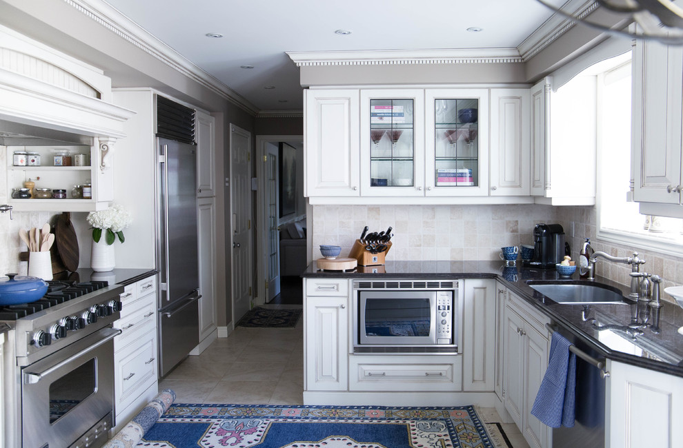 Inspiration for a medium sized classic galley enclosed kitchen in Toronto with a built-in sink, shaker cabinets, white cabinets, granite worktops, beige splashback, terracotta splashback, stainless steel appliances and an island.