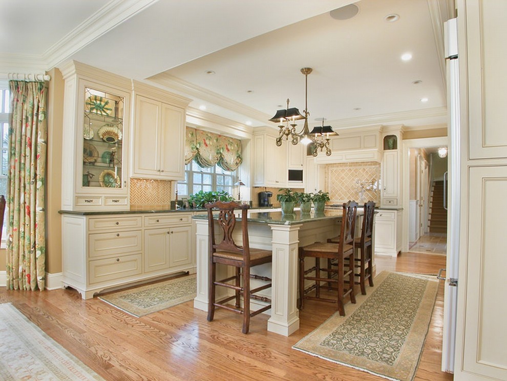 Example of a classic u-shaped kitchen design in New York with recessed-panel cabinets, beige cabinets and beige backsplash