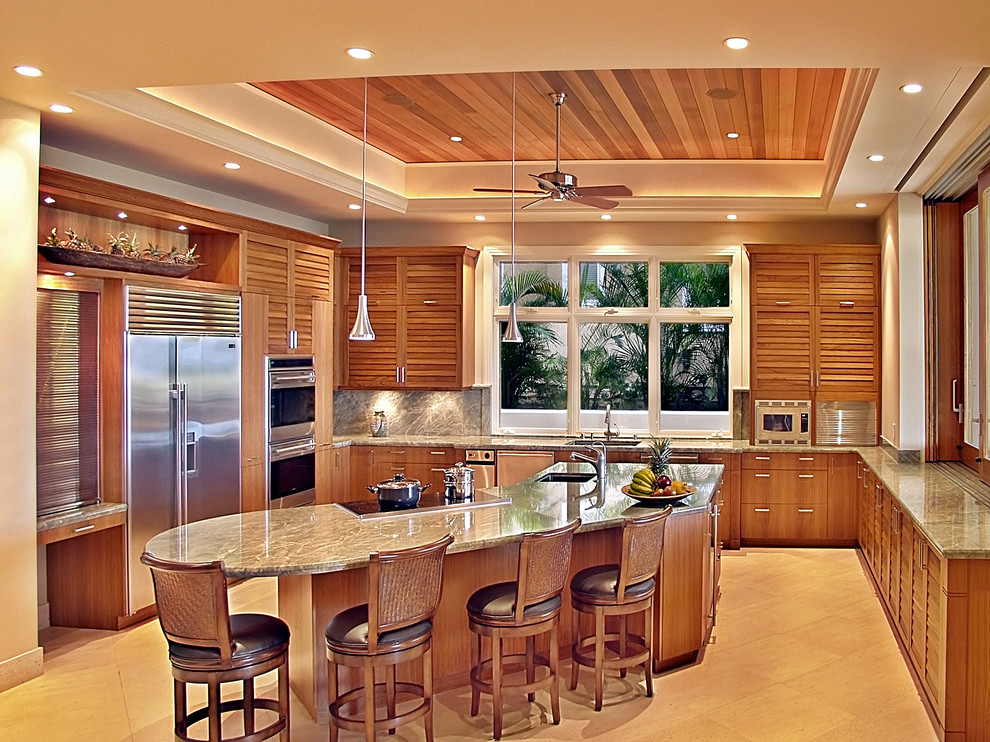 Inspiration for a mid-sized tropical u-shaped travertine floor open concept kitchen remodel in Hawaii with an undermount sink, louvered cabinets, medium tone wood cabinets, marble countertops, beige backsplash, stone slab backsplash, stainless steel appliances and an island
