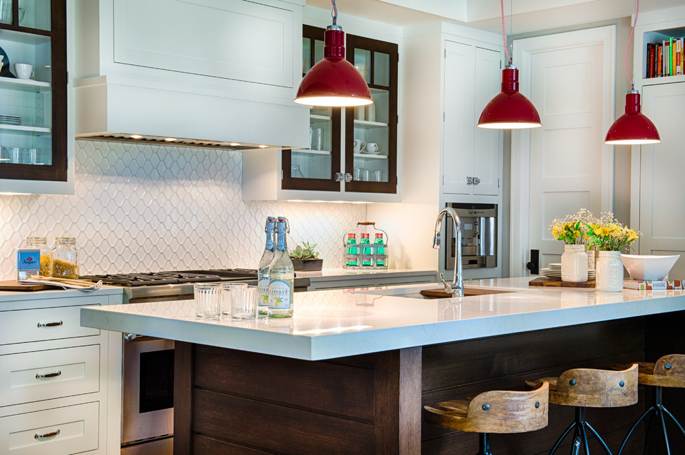 Inspiration for a mid-sized transitional l-shaped medium tone wood floor and brown floor eat-in kitchen remodel in Minneapolis with an undermount sink, beaded inset cabinets, white cabinets, quartz countertops, white backsplash, stone slab backsplash, stainless steel appliances and an island