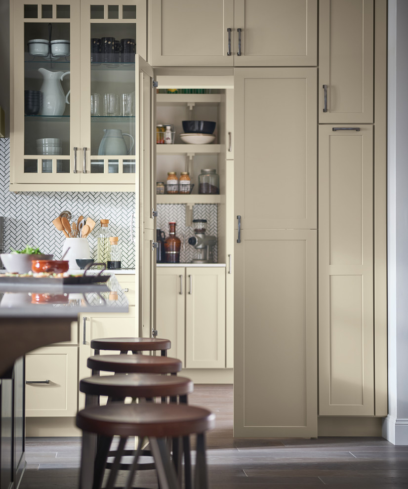 Large traditional l-shaped kitchen pantry in Other with a submerged sink, shaker cabinets, white cabinets, white splashback, stainless steel appliances, dark hardwood flooring, an island, brown floors and white worktops.