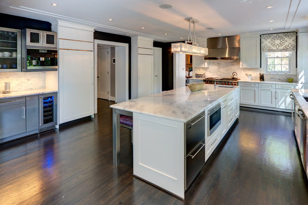 This is an example of a large classic l-shaped kitchen/diner in DC Metro with a submerged sink, shaker cabinets, white cabinets, marble worktops, white splashback, marble splashback, stainless steel appliances, dark hardwood flooring, an island, brown floors and white worktops.
