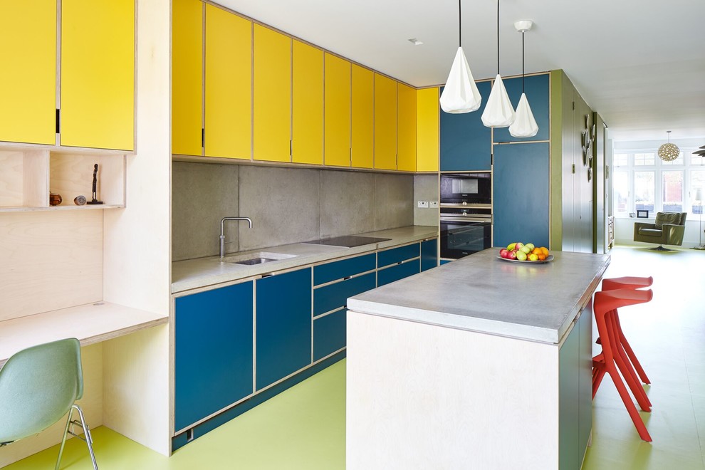 Design ideas for a medium sized contemporary l-shaped open plan kitchen in London with a submerged sink, flat-panel cabinets, yellow cabinets, concrete worktops, cement tile splashback, black appliances, an island and grey splashback.