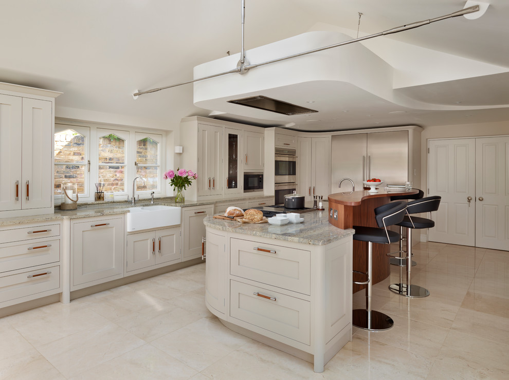 Inspiration for a large transitional eat-in kitchen remodel in London with gray cabinets, granite countertops, stainless steel appliances, an island and a farmhouse sink