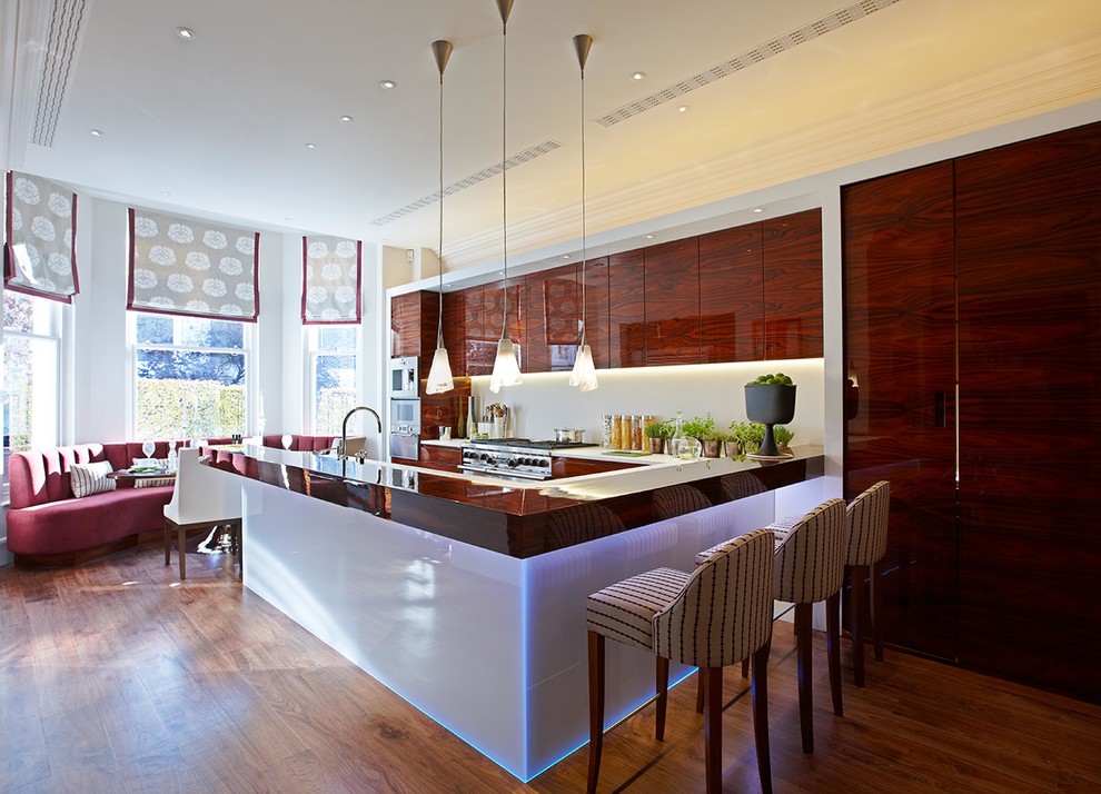 Inspiration for a medium sized contemporary u-shaped kitchen in London with flat-panel cabinets, a breakfast bar, brown floors, red cabinets, medium hardwood flooring and brown worktops.