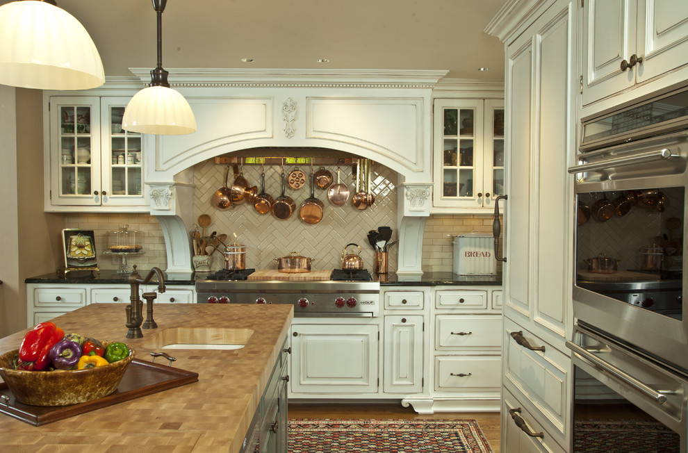 Photo of a traditional kitchen in New York with a submerged sink and a feature wall.