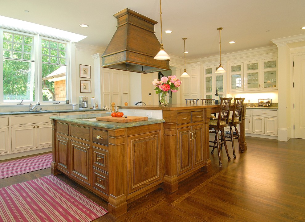 This is an example of a traditional kitchen in San Francisco with glass-front cabinets and white cabinets.