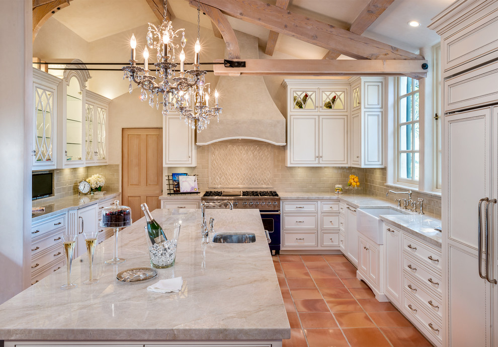 Inspiration for a large timeless u-shaped terra-cotta tile eat-in kitchen remodel in San Francisco with a farmhouse sink, glass-front cabinets, white cabinets, granite countertops, beige backsplash, subway tile backsplash, colored appliances and an island
