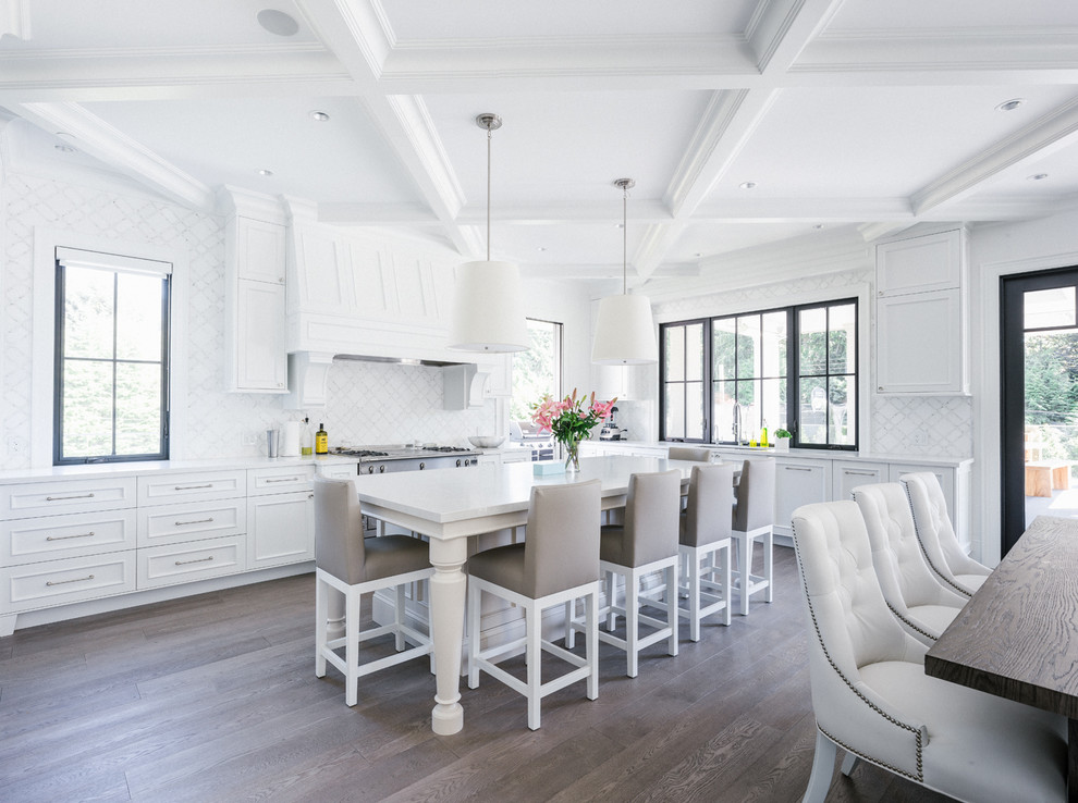Large elegant l-shaped dark wood floor and brown floor eat-in kitchen photo in Vancouver with recessed-panel cabinets, white cabinets, white backsplash, an island, an undermount sink, quartzite countertops and stainless steel appliances