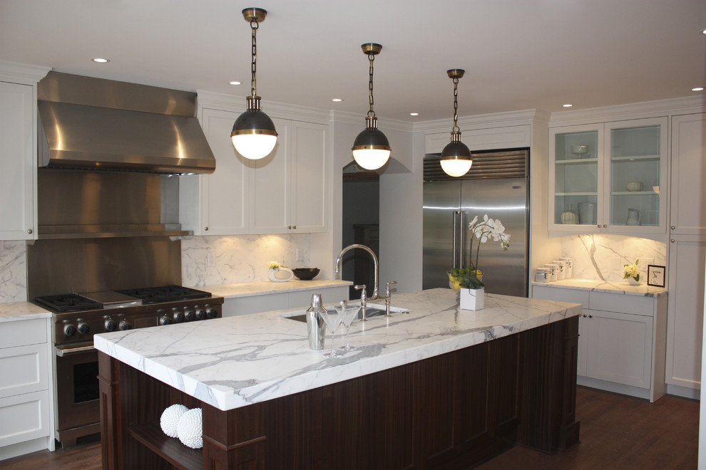 Kitchen - contemporary kitchen idea in Vancouver with stainless steel appliances and marble backsplash