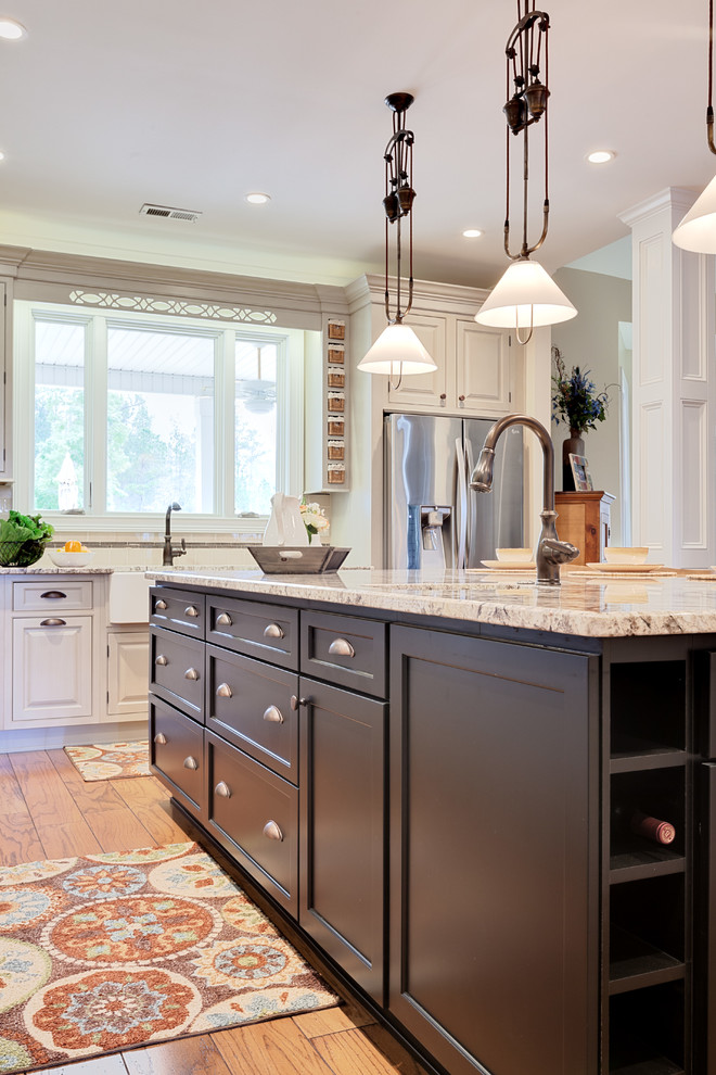 Inspiration for a huge timeless l-shaped medium tone wood floor and brown floor eat-in kitchen remodel in Atlanta with a farmhouse sink, shaker cabinets, black cabinets, granite countertops, beige backsplash, porcelain backsplash, stainless steel appliances, an island and beige countertops