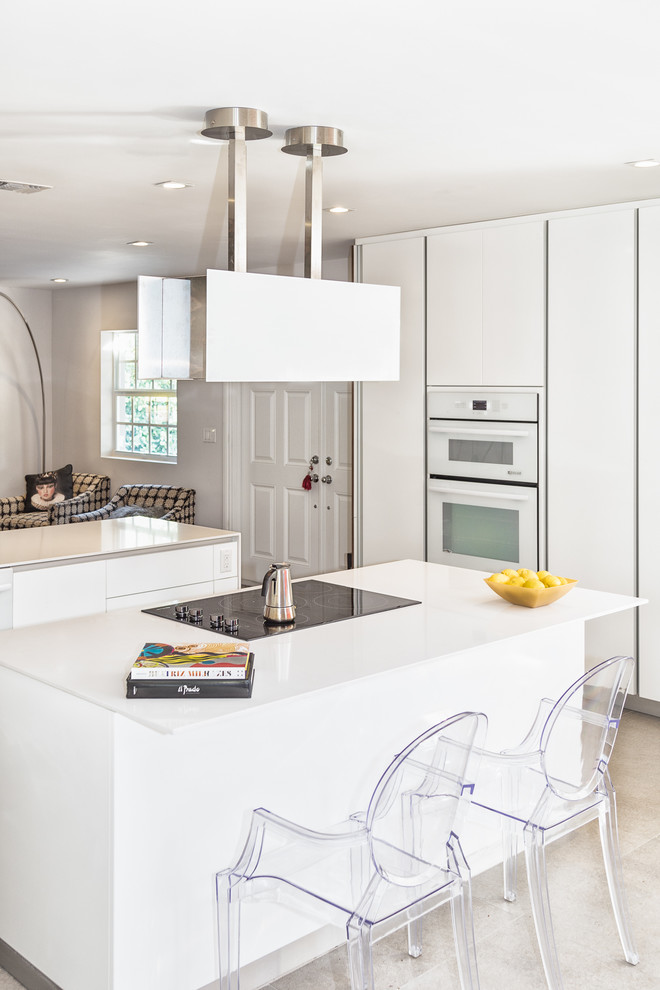 This is an example of a medium sized eclectic l-shaped kitchen/diner in Miami with a submerged sink, flat-panel cabinets, white cabinets, composite countertops, multi-coloured splashback, ceramic splashback, stainless steel appliances, ceramic flooring, an island and beige floors.