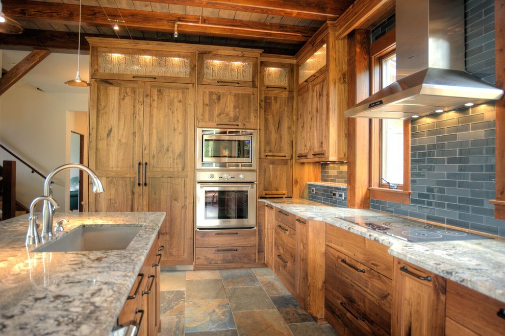 Inspiration for a large rustic l-shaped slate floor and multicolored floor open concept kitchen remodel in Denver with an undermount sink, shaker cabinets, medium tone wood cabinets, granite countertops, blue backsplash, glass tile backsplash, stainless steel appliances, an island and multicolored countertops