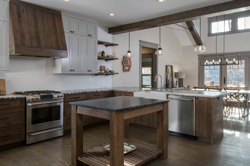 Bild på ett mellanstort amerikanskt kök, med en rustik diskho, skåp i shakerstil, skåp i mellenmörkt trä, granitbänkskiva, vitt stänkskydd, stänkskydd i keramik, rostfria vitvaror, mellanmörkt trägolv, en köksö och brunt golv