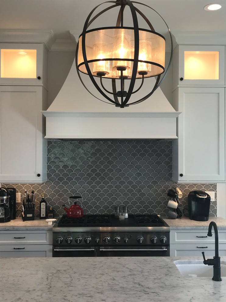 Inspiration for a large classic kitchen in Charleston with recessed-panel cabinets, black cabinets, composite countertops, grey splashback, ceramic splashback, stainless steel appliances, dark hardwood flooring, black floors and white worktops.