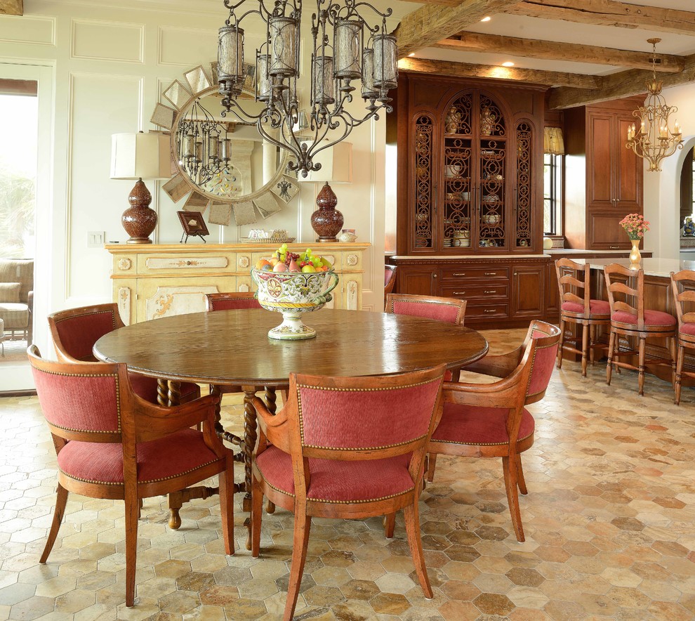 Example of a large tuscan limestone floor kitchen/dining room combo design in Charleston