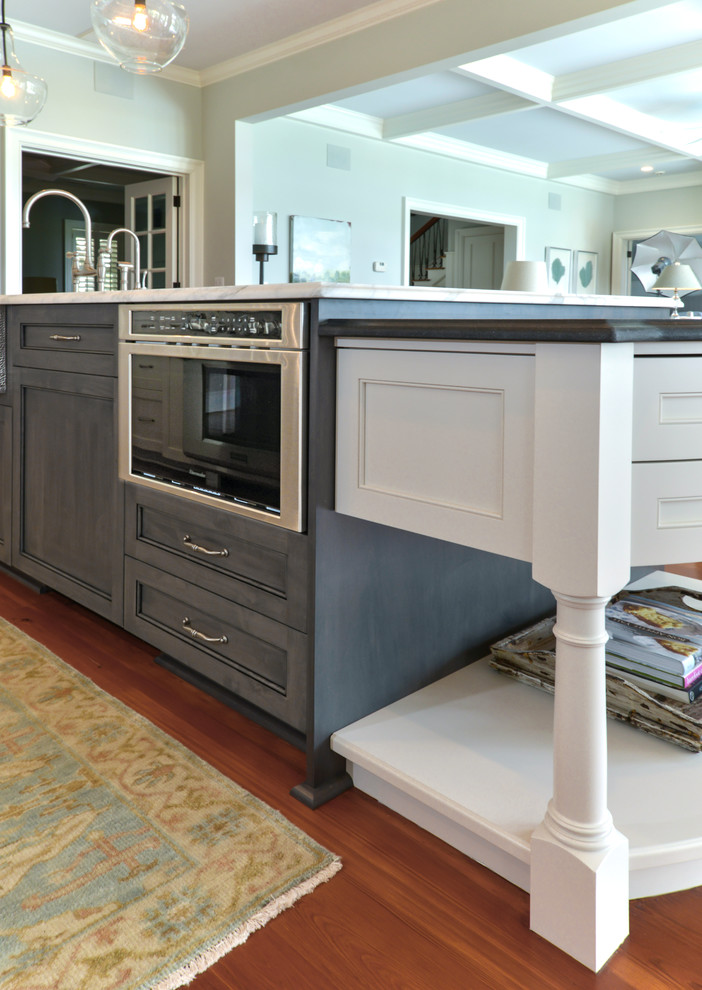 Mid-sized elegant single-wall kitchen photo in Charleston with a farmhouse sink, paneled appliances, an island and recessed-panel cabinets